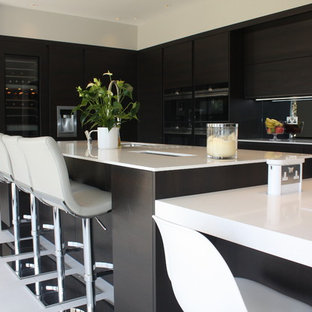 Inspiration for a mid-sized modern l-shaped open concept kitchen remodel in Other with flat-panel cabinets, quartzite countertops, metallic backsplash, mirror backsplash, stainless steel appliances and two islands
