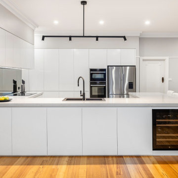 Sleek minimalist family kitchen in Ashburton