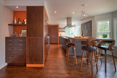 Eat-in kitchen - large contemporary l-shaped medium tone wood floor eat-in kitchen idea in Portland with an undermount sink, flat-panel cabinets, medium tone wood cabinets, quartzite countertops, stainless steel appliances, an island and white countertops