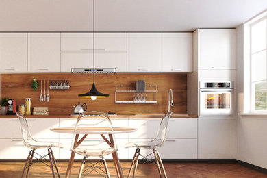 Modelo de cocina comedor lineal moderna pequeña con fregadero de doble seno, puertas de armario blancas, encimera de madera y suelo de madera clara