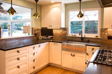 Example of a small eclectic u-shaped bamboo floor enclosed kitchen design in San Francisco with a farmhouse sink, shaker cabinets, beige cabinets, quartzite countertops, metallic backsplash, glass tile backsplash, stainless steel appliances and no island
