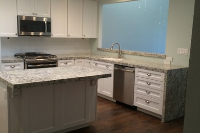 Elegant l-shaped kitchen photo in Orange County