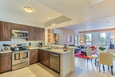 Example of a small trendy u-shaped medium tone wood floor and beige floor eat-in kitchen design in San Francisco with an undermount sink, flat-panel cabinets, medium tone wood cabinets, quartz countertops, stainless steel appliances and a peninsula