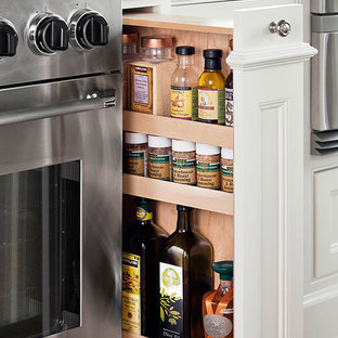 Contemporary eat-in kitchen remodeling - Eat-in kitchen - contemporary galley eat-in kitchen idea in Los Angeles with an undermount sink, glass-front cabinets, white cabinets, quartzite countertops, glass tile backsplash and stainless steel appliances