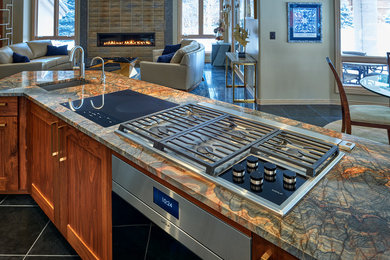 Inspiration for a mid-sized eclectic l-shaped black floor eat-in kitchen remodel in Denver with an undermount sink, shaker cabinets, granite countertops, stainless steel appliances, an island and multicolored countertops