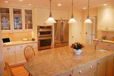 Example of a large trendy u-shaped light wood floor eat-in kitchen design in Denver with a drop-in sink, recessed-panel cabinets, white cabinets, granite countertops, multicolored backsplash, mosaic tile backsplash, stainless steel appliances and an island