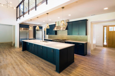 Design ideas for a medium sized classic l-shaped open plan kitchen in Seattle with a submerged sink, recessed-panel cabinets, green cabinets, composite countertops, green splashback, ceramic splashback, stainless steel appliances, medium hardwood flooring, an island and beige floors.