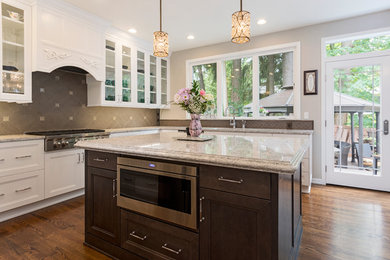 Eat-in kitchen - large transitional l-shaped medium tone wood floor and brown floor eat-in kitchen idea in Boise with an undermount sink, shaker cabinets, white cabinets, quartz countertops, gray backsplash, porcelain backsplash, stainless steel appliances, an island and gray countertops