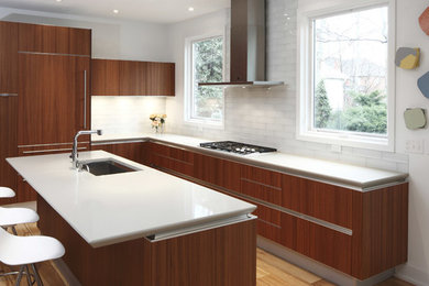 Large trendy light wood floor eat-in kitchen photo in New York with a single-bowl sink, medium tone wood cabinets, white backsplash, stainless steel appliances and an island