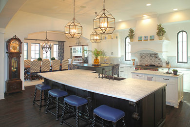 Southwest kitchen photo in Tampa with recessed-panel cabinets, light wood cabinets and two islands