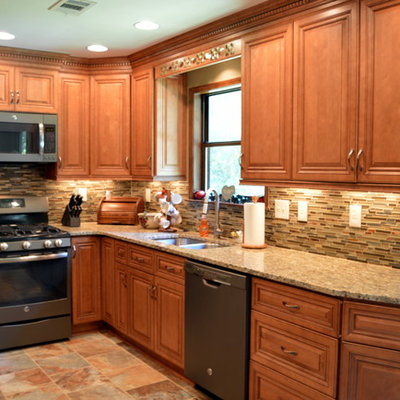 Inspiration for a mid-sized transitional l-shaped slate floor eat-in kitchen remodel in Atlanta with a double-bowl sink, raised-panel cabinets, medium tone wood cabinets, granite countertops, green backsplash, stone tile backsplash and colored appliances