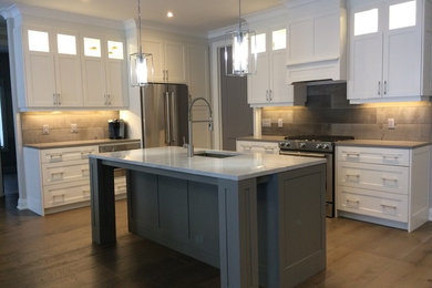 Inspiration for a mid-sized modern l-shaped medium tone wood floor eat-in kitchen remodel in Toronto with an undermount sink, shaker cabinets, white cabinets, quartz countertops, brown backsplash, wood backsplash, stainless steel appliances and an island
