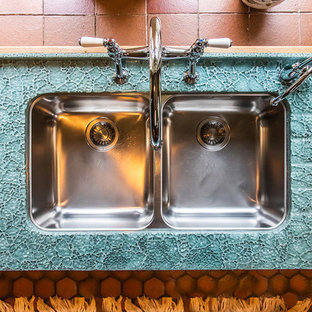 Inspiration for a mid-sized traditional u-shaped eat-in kitchen in Other with a double-bowl sink, shaker cabinets, medium wood cabinets, glass benchtops, multi-coloured splashback, glass tile splashback, white appliances, terra-cotta floors, no island, orange floor and green benchtop.