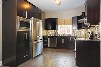 Example of a large trendy u-shaped ceramic tile enclosed kitchen design in Toronto with an undermount sink, shaker cabinets, dark wood cabinets, granite countertops, multicolored backsplash, matchstick tile backsplash, stainless steel appliances and no island