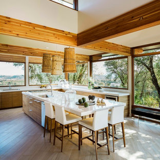 Inspiration for a contemporary open plan kitchen in San Francisco with a submerged sink, flat-panel cabinets, medium wood cabinets, light hardwood flooring and an island.