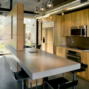 Mid-sized minimalist galley concrete floor eat-in kitchen photo in Phoenix with an undermount sink, flat-panel cabinets, light wood cabinets, concrete countertops, metallic backsplash, metal backsplash, stainless steel appliances and an island