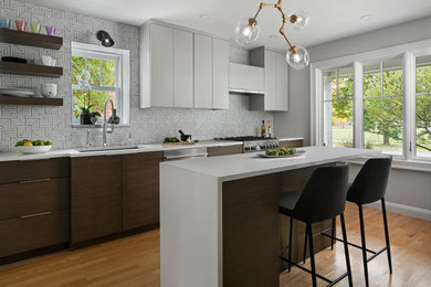 Mid-sized minimalist l-shaped light wood floor eat-in kitchen photo in Detroit with a double-bowl sink, flat-panel cabinets, gray cabinets, quartz countertops, gray backsplash, mosaic tile backsplash, stainless steel appliances, an island and white countertops