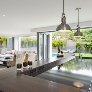 This is an example of a contemporary open plan kitchen in Sydney with an undermount sink and quartz benchtops.