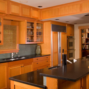Design ideas for a large arts and crafts galley open plan kitchen in Seattle with an undermount sink, shaker cabinets, light wood cabinets, granite benchtops, grey splashback, slate splashback, panelled appliances, slate floors, a peninsula, multi-coloured floor and black benchtop.