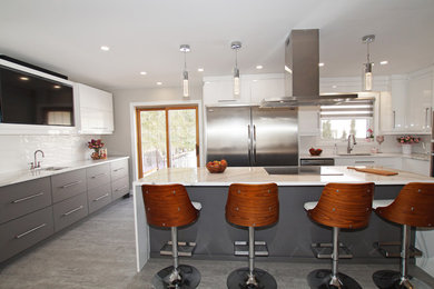 Mid-sized minimalist galley eat-in kitchen photo in Toronto with an undermount sink, flat-panel cabinets, white cabinets, quartzite countertops, white backsplash, ceramic backsplash, stainless steel appliances, an island and white countertops