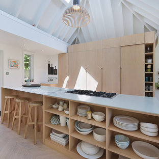 Inspiration for a medium sized scandi kitchen in London with flat-panel cabinets, light wood cabinets, marble worktops, light hardwood flooring, an island, beige floors and grey worktops.