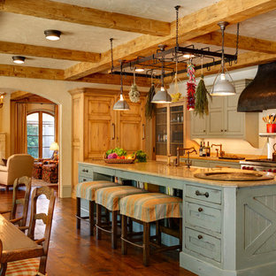 Inspiration for an expansive eat-in kitchen in Chicago with recessed-panel cabinets, green cabinets, limestone benchtops, white splashback, ceramic splashback, stainless steel appliances, dark hardwood floors and with island.