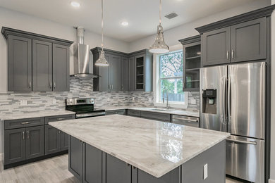 Minimalist kitchen photo in Tampa with shaker cabinets and gray cabinets