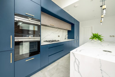 Design ideas for a medium sized contemporary open plan kitchen in London with a single-bowl sink, flat-panel cabinets, blue cabinets, quartz worktops, white splashback, marble splashback, stainless steel appliances, cement flooring, an island, grey floors and yellow worktops.
