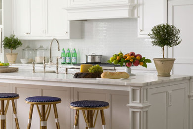Inspiration for a timeless kitchen remodel in New York with recessed-panel cabinets, white cabinets and an island