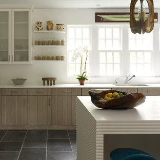 Photo of a mid-sized contemporary u-shaped separate kitchen in New York with an undermount sink, louvered cabinets, light wood cabinets, white splashback, with island, solid surface benchtops, stainless steel appliances and slate floors.