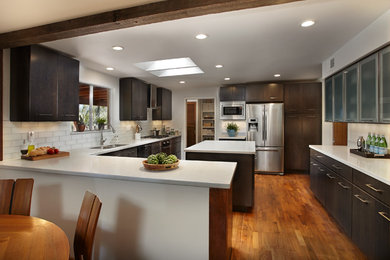 Kitchen - contemporary u-shaped kitchen idea in Phoenix with shaker cabinets, dark wood cabinets, quartz countertops and white backsplash