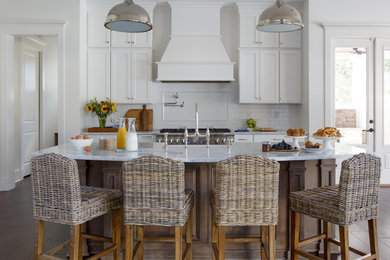 Eat-in kitchen - farmhouse galley dark wood floor eat-in kitchen idea in Jacksonville with a farmhouse sink, white cabinets, white backsplash, subway tile backsplash, stainless steel appliances, an island, shaker cabinets and marble countertops
