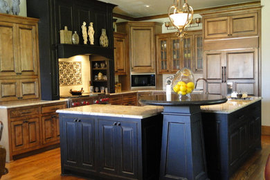 Example of a mid-sized arts and crafts l-shaped medium tone wood floor eat-in kitchen design in Dallas with an undermount sink, recessed-panel cabinets, medium tone wood cabinets, granite countertops, beige backsplash, ceramic backsplash, stainless steel appliances and an island