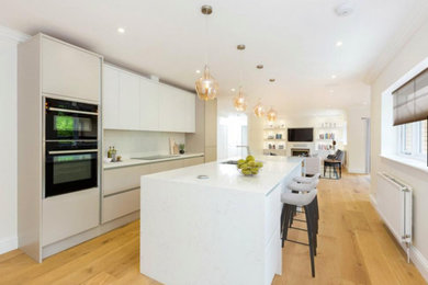 Large classic single-wall kitchen/diner in London with an island.