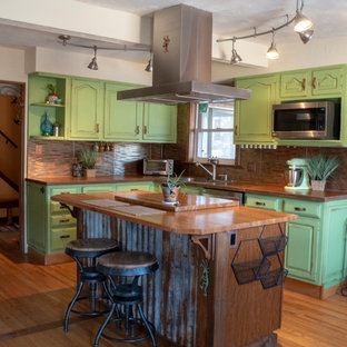 Photo of a mid-sized u-shaped eat-in kitchen in Denver with an undermount sink, concrete benchtops, stainless steel appliances, medium hardwood floors and with island.