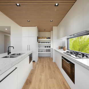 Photo of a mid-sized contemporary kitchen in Sydney with an undermount sink, with island and wood.