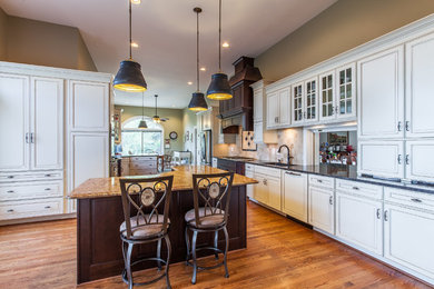 Example of a huge transitional medium tone wood floor eat-in kitchen design in DC Metro with raised-panel cabinets, granite countertops, stainless steel appliances and an island