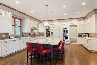 Large elegant kitchen photo in Other with white cabinets, stainless steel appliances and an island