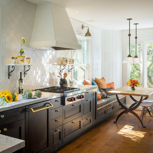 Mediterranean eat-in kitchen inspiration - Inspiration for a mediterranean dark wood floor eat-in kitchen remodel in San Francisco with shaker cabinets, black cabinets, white backsplash and stainless steel appliances