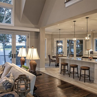 Photo of a large traditional l-shaped eat-in kitchen in Atlanta with an undermount sink, recessed-panel cabinets, white cabinets, granite benchtops, white splashback, subway tile splashback, stainless steel appliances, porcelain floors and multiple islands.