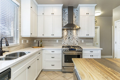 Mid-sized southwest l-shaped ceramic tile and brown floor open concept kitchen photo in Other with a double-bowl sink, shaker cabinets, white cabinets, wood countertops, gray backsplash, porcelain backsplash, stainless steel appliances, an island and brown countertops