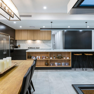 Inspiration for a large contemporary l-shaped eat-in kitchen in Brisbane with an undermount sink, light wood cabinets, marble benchtops, white splashback, marble splashback, stainless steel appliances, porcelain floors, with island, grey floor, white benchtop and flat-panel cabinets.