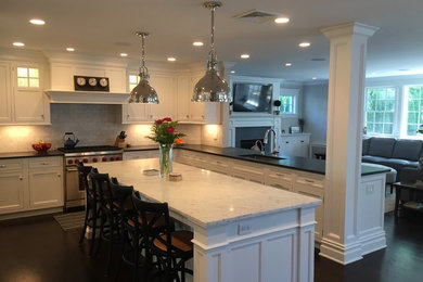 Example of a large classic u-shaped dark wood floor open concept kitchen design in New York with an undermount sink, beaded inset cabinets, white cabinets, marble countertops, gray backsplash, subway tile backsplash, paneled appliances and an island