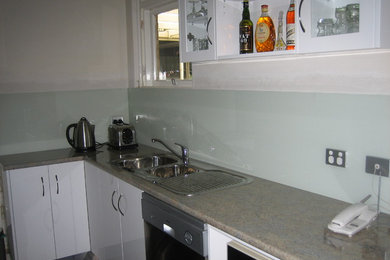This is an example of a modern kitchen in Adelaide with blue splashback.