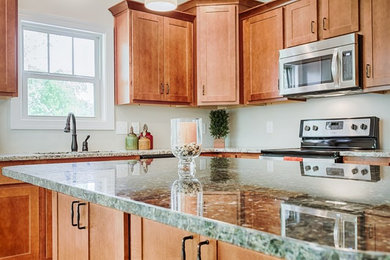Transitional eat-in kitchen photo in Other with granite countertops