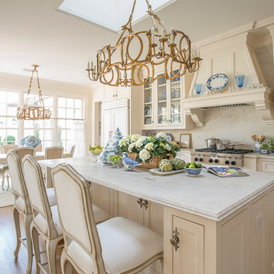 Open concept kitchen - large traditional l-shaped medium tone wood floor and brown floor open concept kitchen idea in Dallas with shaker cabinets, white cabinets, marble countertops, white backsplash, an island, an undermount sink, paneled appliances and marble backsplash