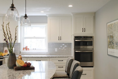 Inspiration for a large transitional l-shaped eat-in kitchen remodel in Minneapolis with shaker cabinets and an island