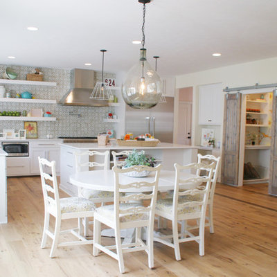 Inspiration for a timeless eat-in kitchen remodel in Grand Rapids with open cabinets, white cabinets, green backsplash and stainless steel appliances