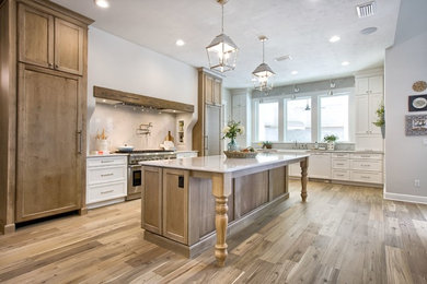 Transitional light wood floor open concept kitchen photo in Jacksonville with a farmhouse sink, shaker cabinets, white cabinets, stainless steel appliances, an island and white countertops
