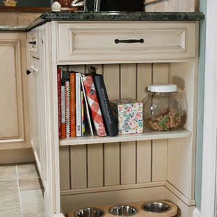 Mid-sized traditional u-shaped eat-in kitchen in New York with an undermount sink, recessed-panel cabinets, beige cabinets, granite benchtops, beige splashback, ceramic splashback, stainless steel appliances, ceramic floors and a peninsula.